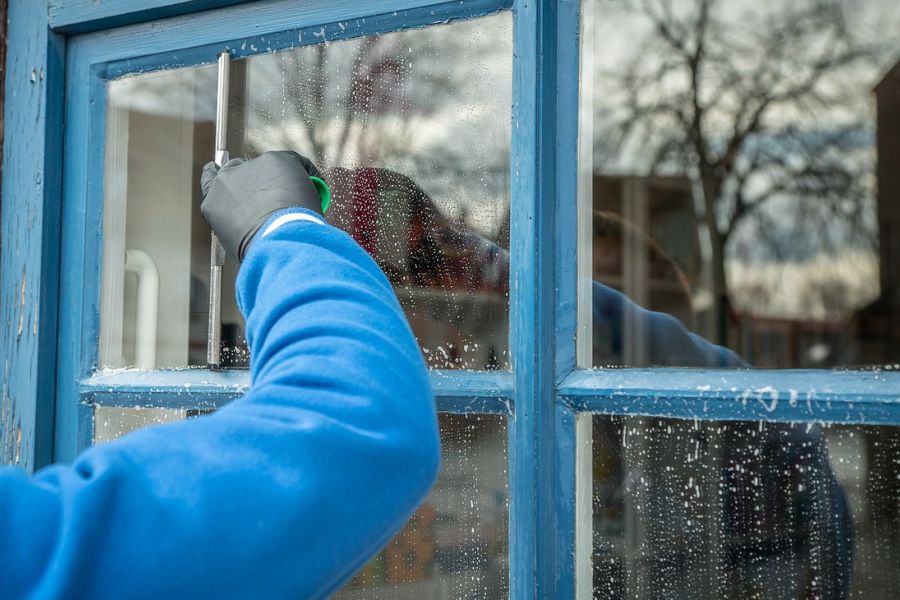 man cleaning a window