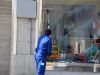 Window cleaner cleaning shop window