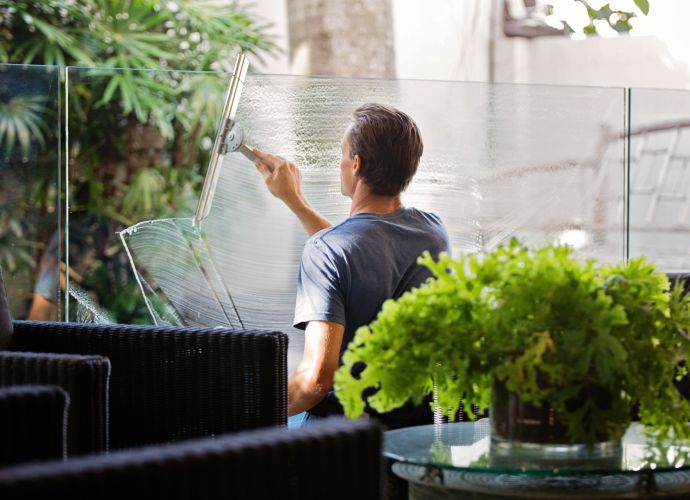 man cleaning a window in a hotel