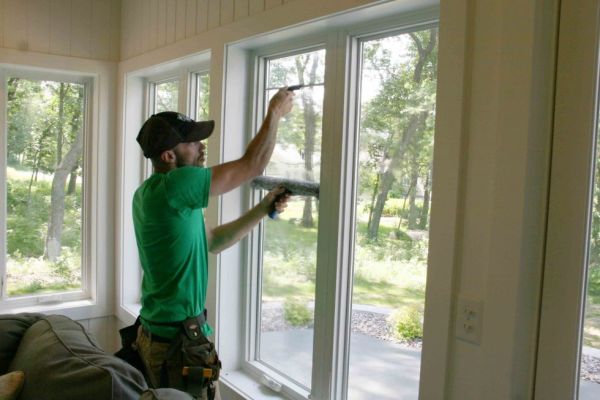man cleaning the inside of a window