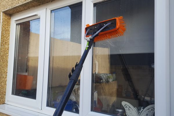 water fed pole cleaing outside a upstairs window