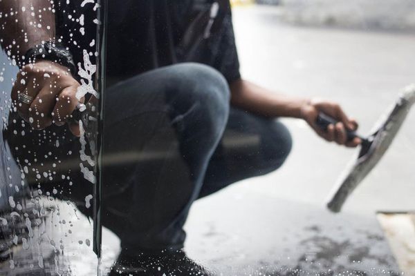 man cleaning the inside of a window
